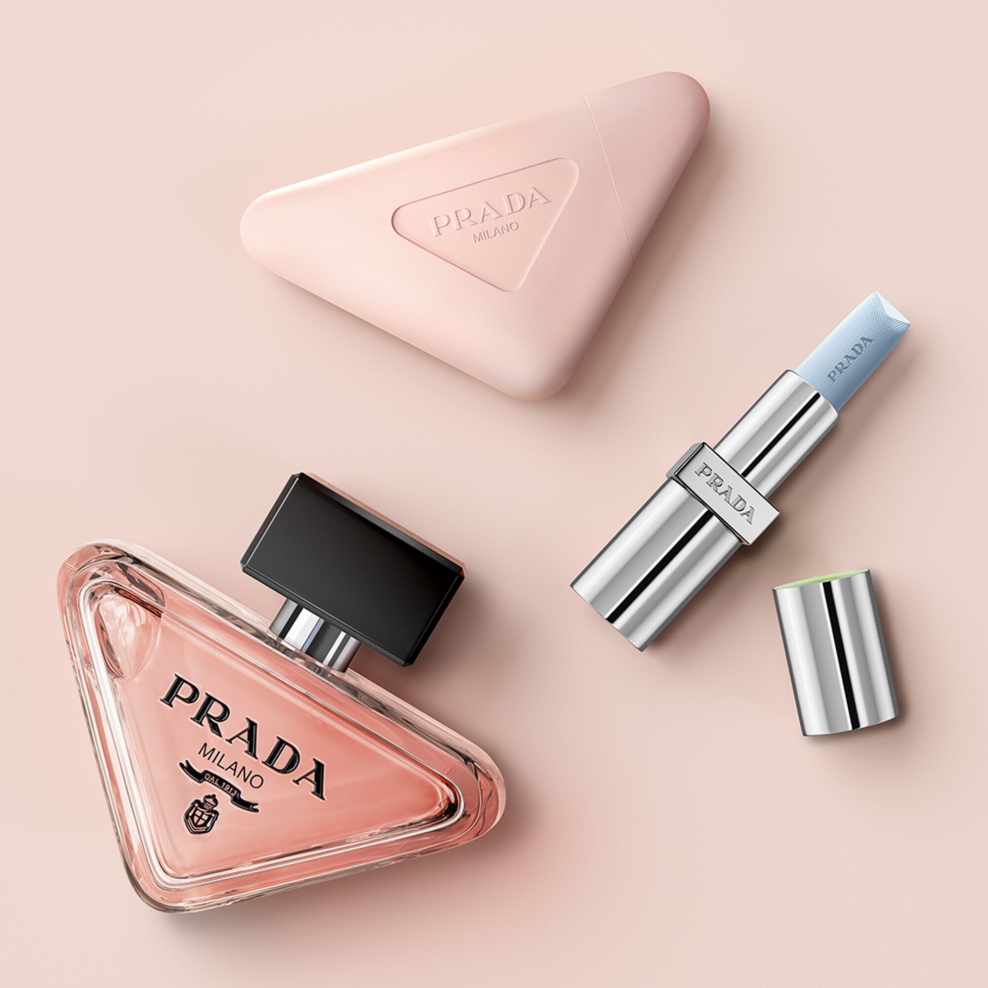 Prada Paradoxe Hand Cream cross sell with Paradoxe Eau de Parfum and Prada Balm on a light pink background