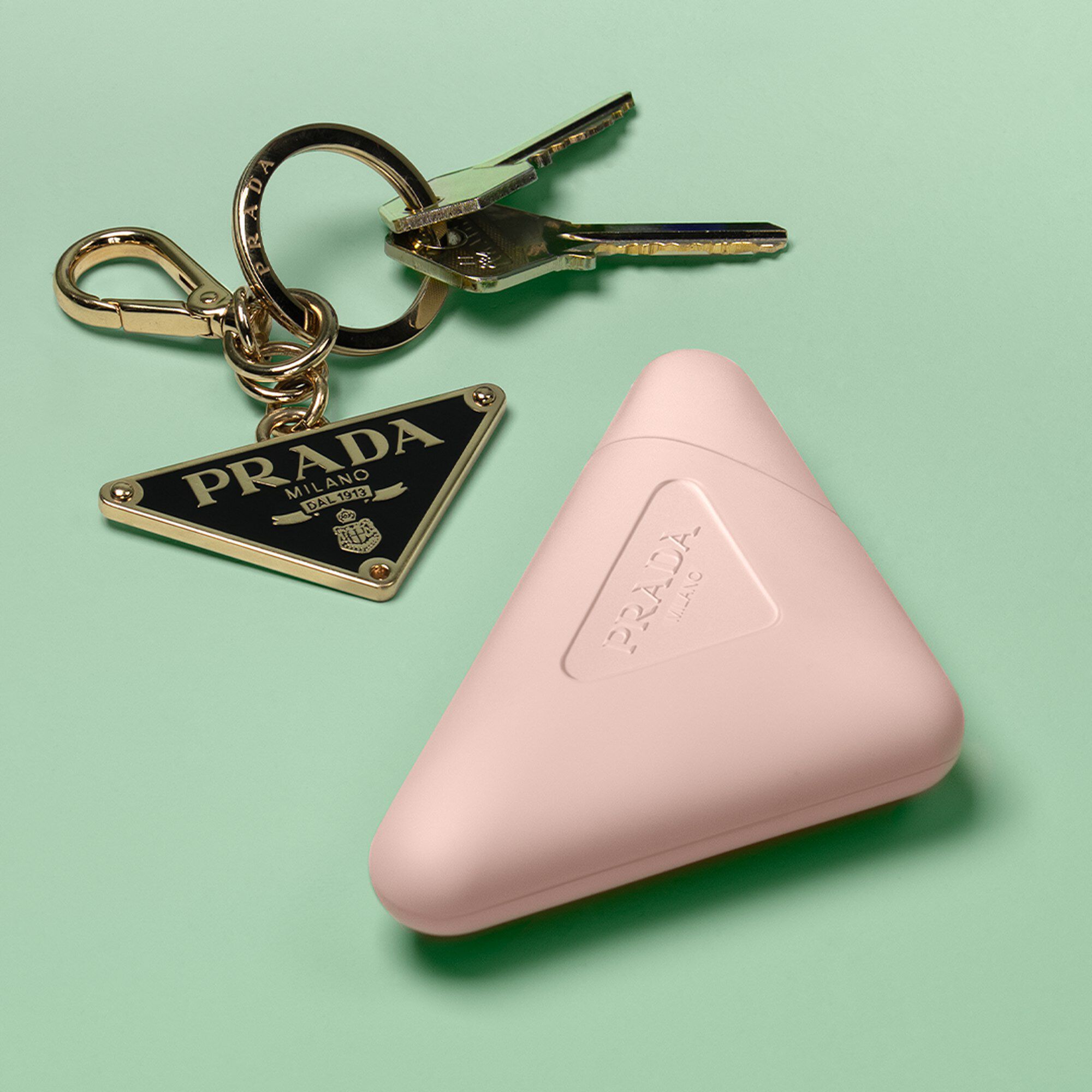 Prada Paradoxe Hand Cream with Prada keys on a Green background